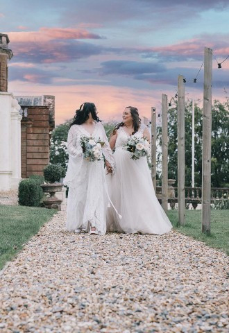 Two brides walking around their wedding venue at sunset, Matt Clarke Photography