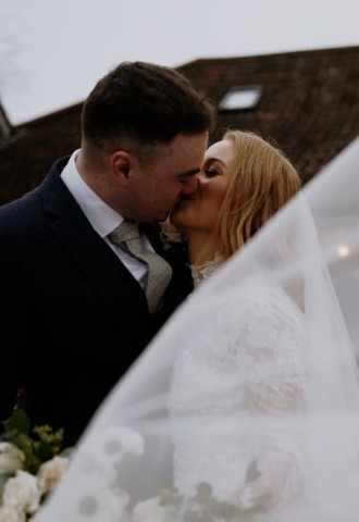 Bride and groom shar a kiss