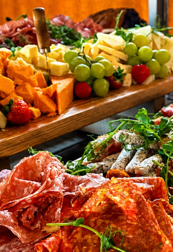 Antipasto grazing boards with cured meats, cheeses, fruit and fresh garnishes at a Lancashire wedding
