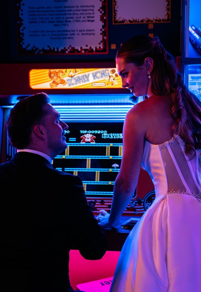 Bride and Groom in Retro Arcade Glow on Wedding Day