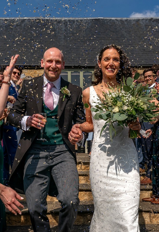 Bride and groom celebrating confetti