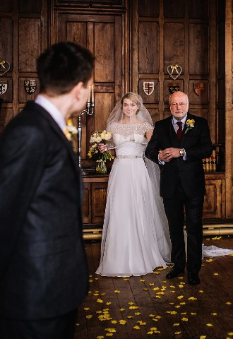 Bride and father of the bride walking down the aisle at Chateau Rhianfa Wedding Venue, Anglesey