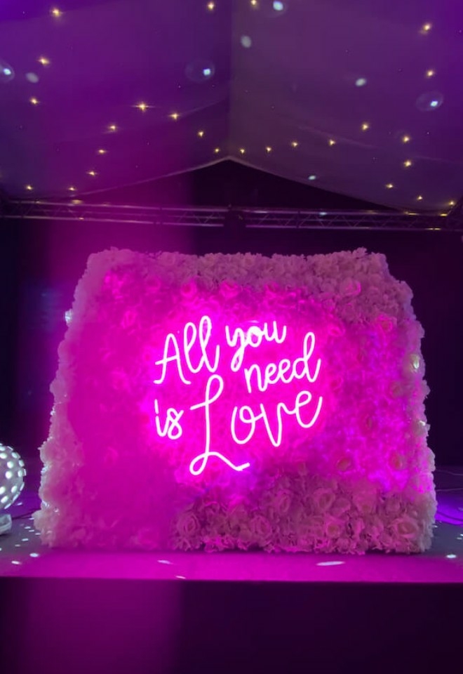 FLORAL DJ STAND WITH ALL YOU NEED IS LOVE NEON SIGN