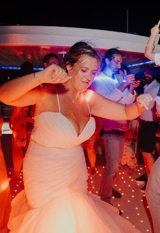 bride enjoys her wedding reception by dancing with guest