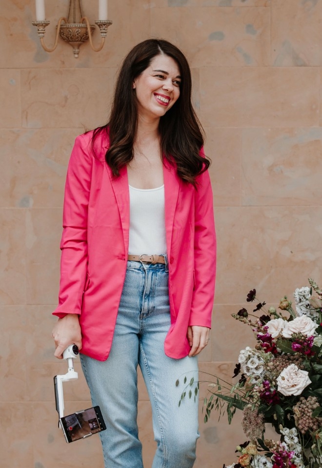 A wedding content creator based in hampshire holding a gimbal and a smartphone