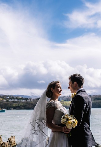 Bride and groom pose for their wedding photography at Chateau Rhianfa, Anglesey