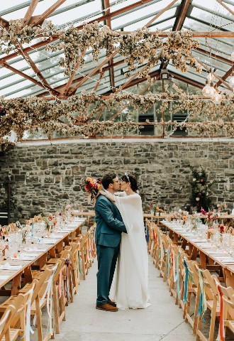 Bride and groom share a kiss at Plas Dinam Wedding Venue, Powys