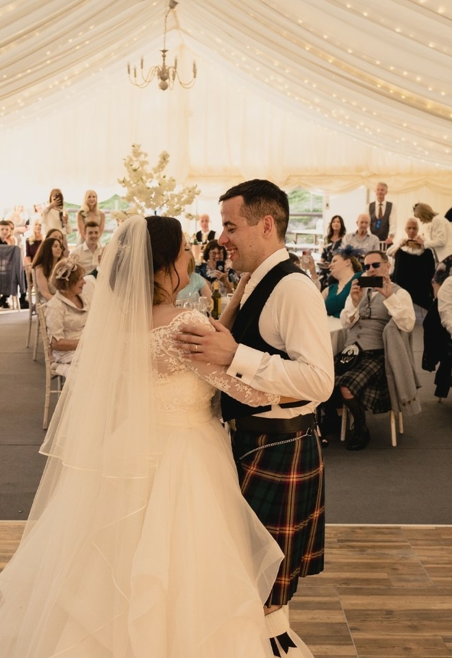 first dance, scottish wedding groom in a kilt in the marquee venue at The Stables Wedding Farm, Oldham