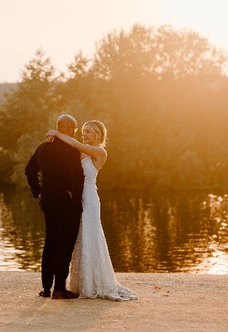 Bride and groom by the river at Bisham Abbey, Berkshire