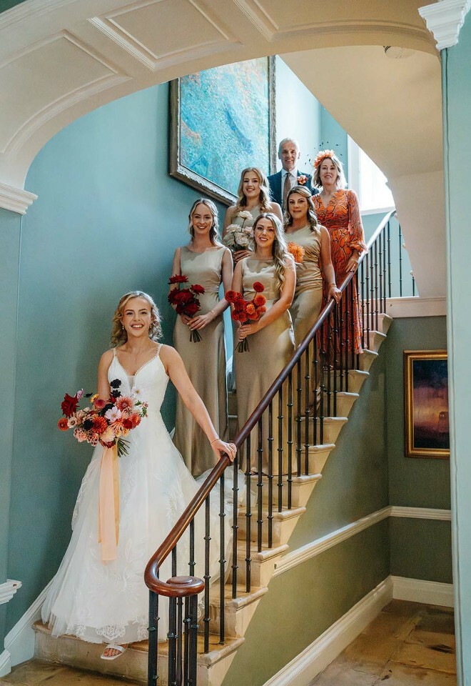 Bride and bridesmaids standing on the stairs