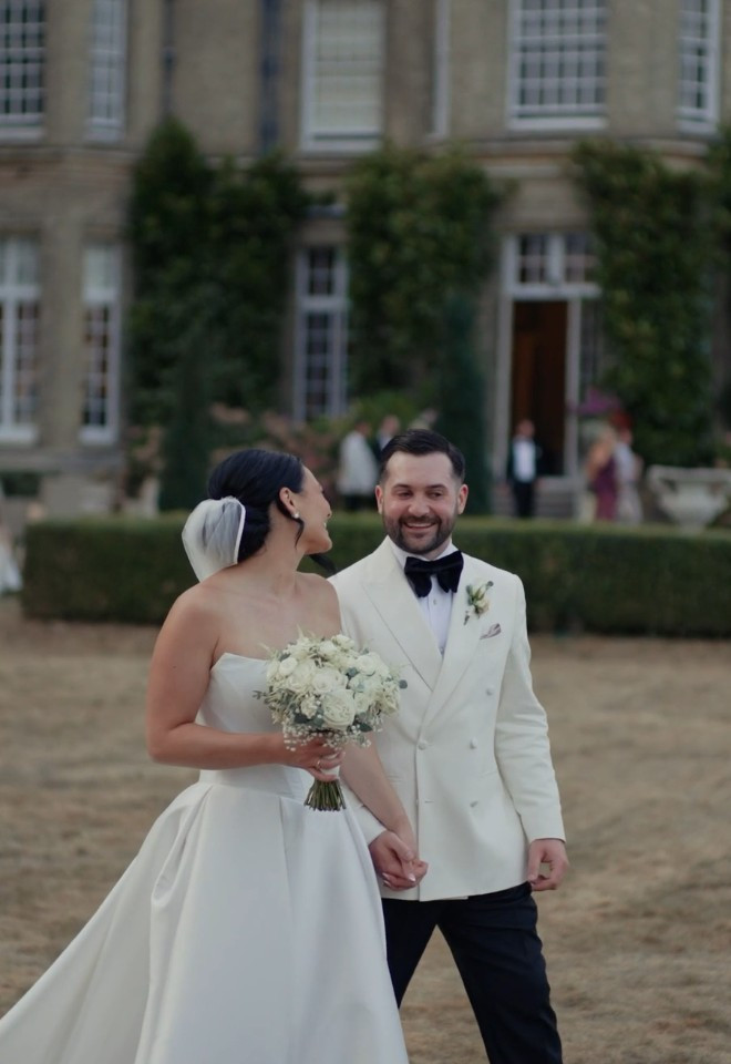 Bride and groom walking together in the grounds of Hedsor House, Buckinghamshire, captured by Dean Sherwood Wedding Films, Hertfordshire wedding videographer.