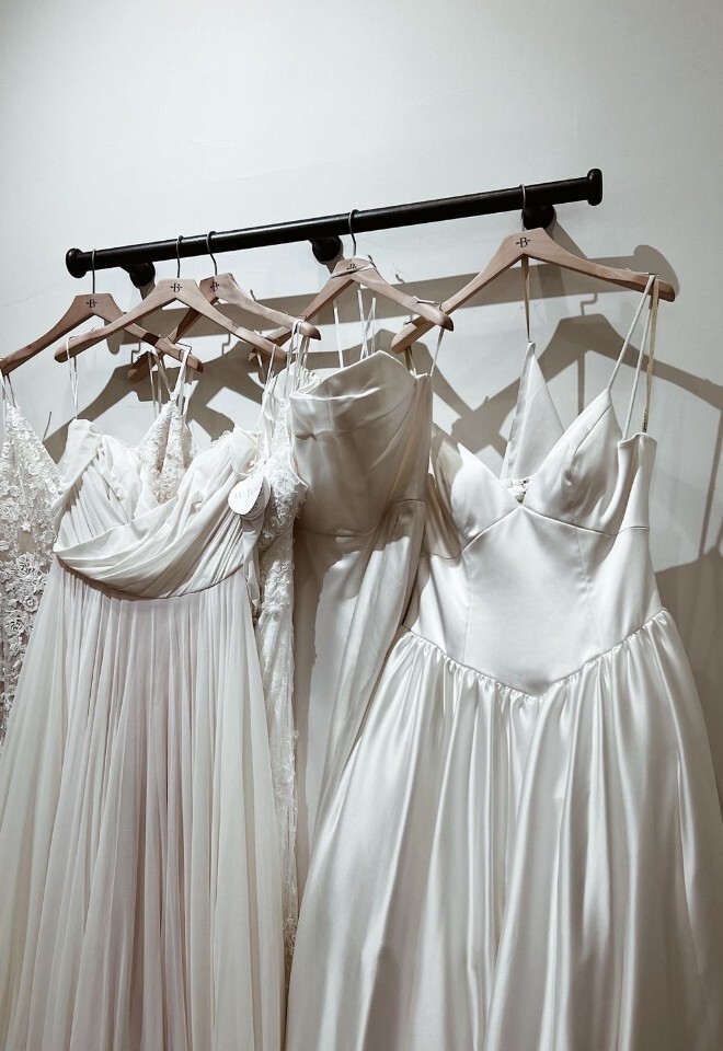 WEDDING DRESSES ALL HANGING ON HANGERS 