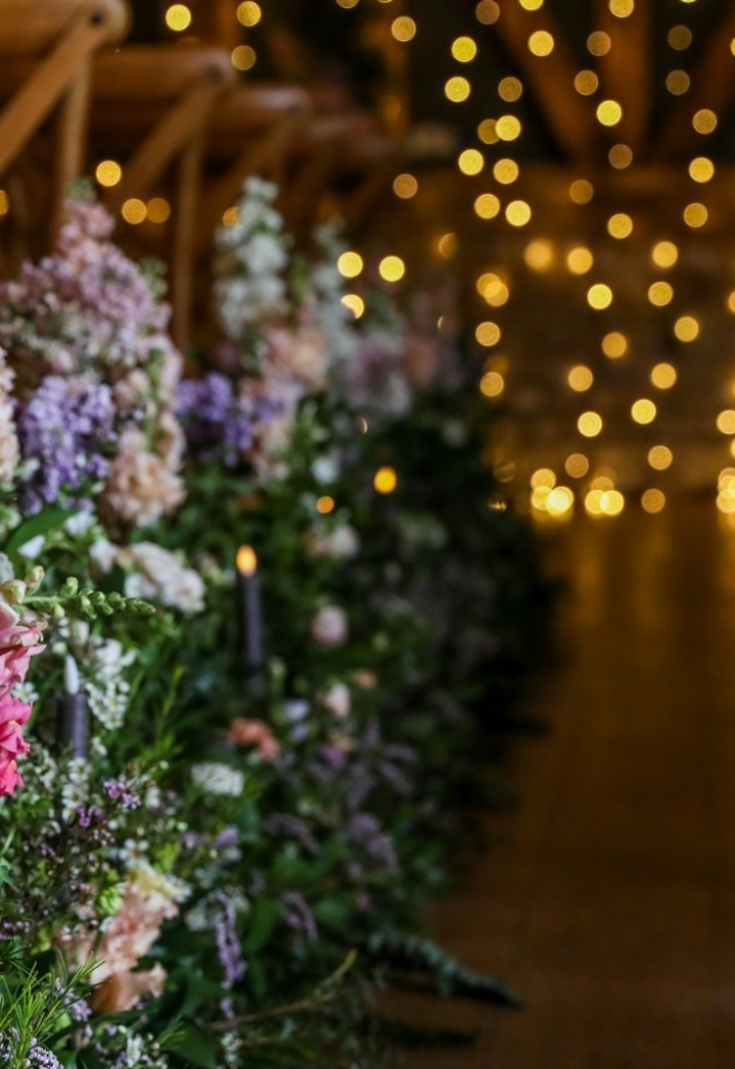 Flowers down the aisle in the Threshing Barn at Silchester Farm