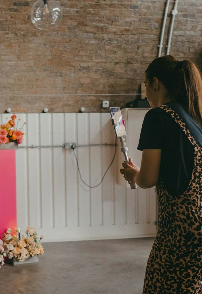 A wedding content creator based in hampshire holding a gimbal and a smartphone