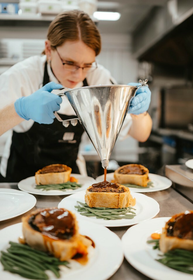 In house catering, head chef putting finishing touches to stunning beef wellington 