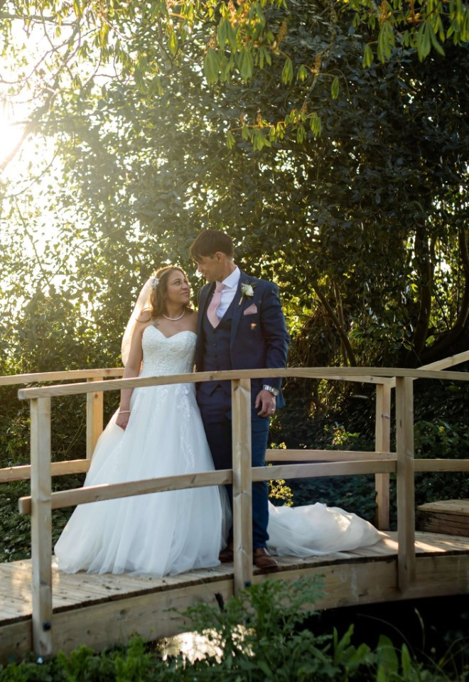 golden hour photo on the bridge of bride & groom at Southend Barns wedding venue in Sussex