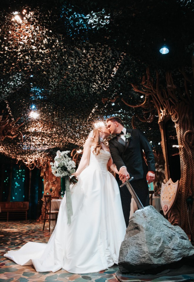 Bride and Groom with Bouqet in Indoor Whispering Woods, pulling out the Sword In The Stone