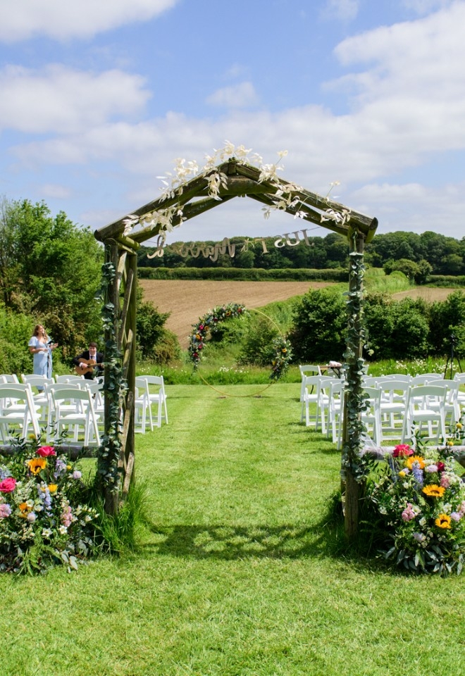Outdoor wedding ceremony overlooking the Buckinghamshire countryside at Monkton Barn