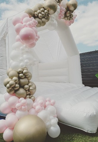 Balloon arch on wedding white bouncy castle hire in Derbyshire