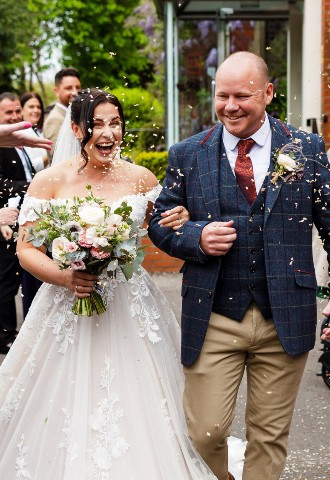 Bride and groom showered in confetti at Coed Y Mwstwr hotel, South Wales