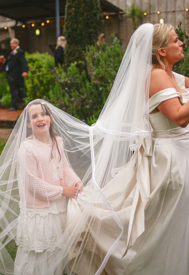 Bride celebrating with guests during relaxed outdoor wedding reception