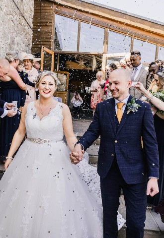 Bride and groom being showered in confetti at Rosedew Farm, Llantwit Major