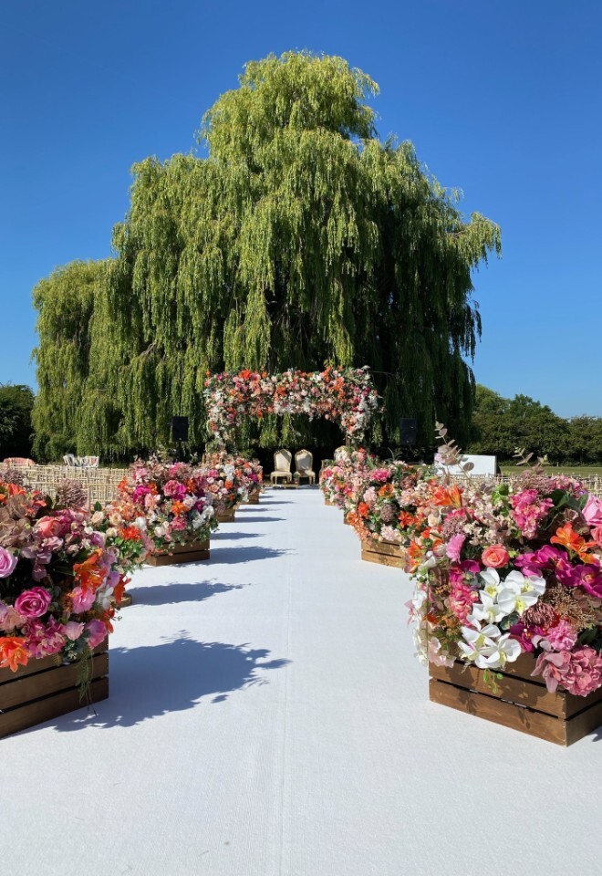Celebrate your special day beneath our stunning willow tree. A picturesque aisle lined with vibrant blooms creates the perfect romantic setting for an unforgettable outdoor ceremony at The Willows.