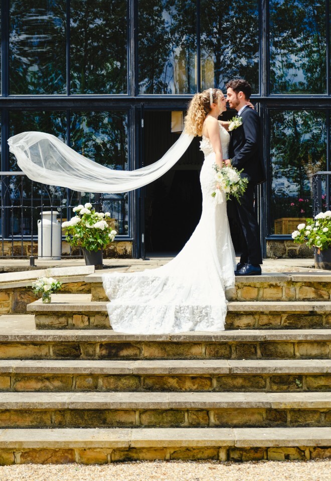 Bride and groom outside Briar House Barns wedding venue in Rotherfield, East Sussex