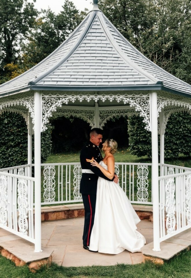 Couple photographed in lawn pagoda