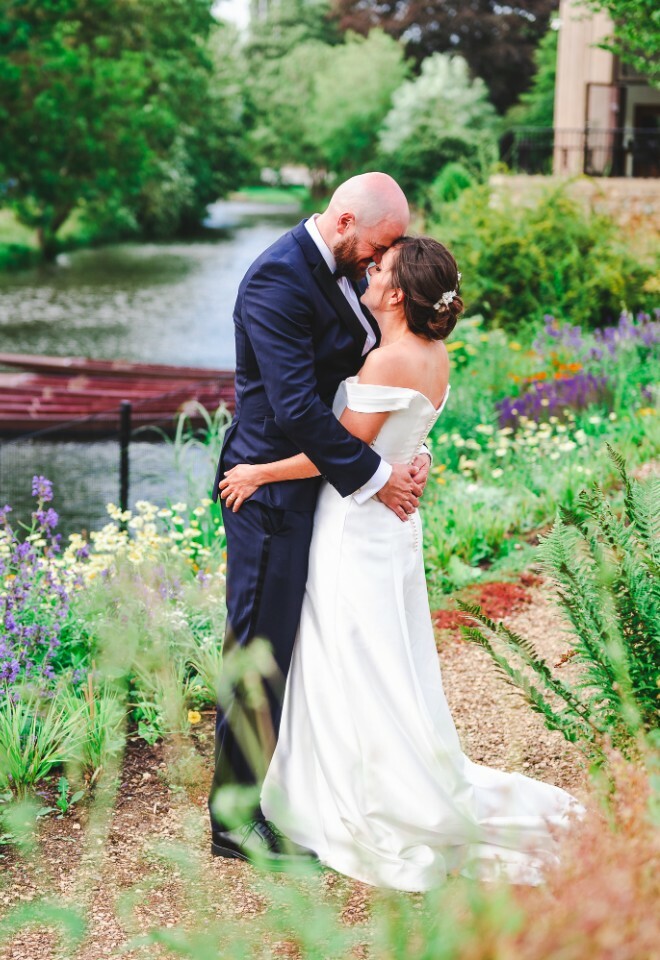 bride and groom next to river in oxford