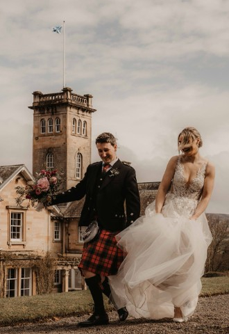 Bride and groom celebrating at Auchen Castle - a romantic castle wedding venue in Scotland
