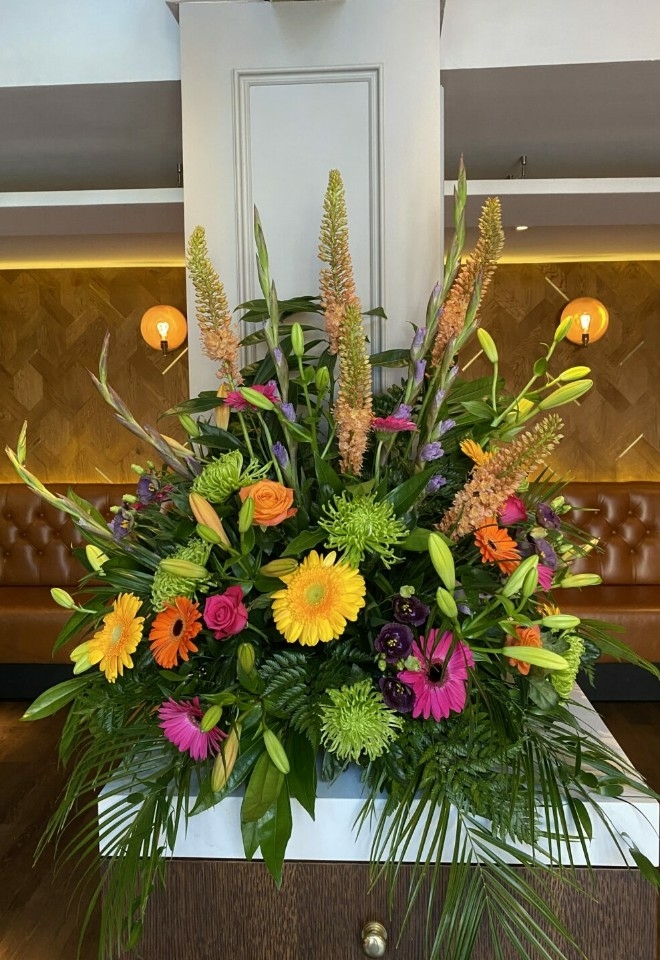 Bright coloured flowers on display by hire heaven