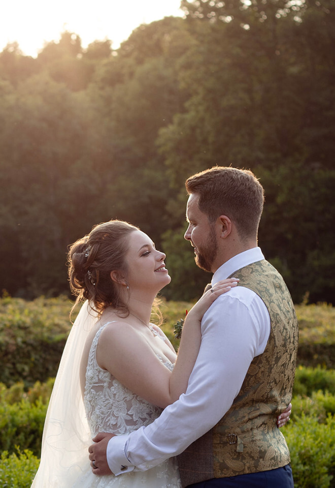 “Bride and groom at golden hour in gardens at Rhinefield House New Forest Hampshire”