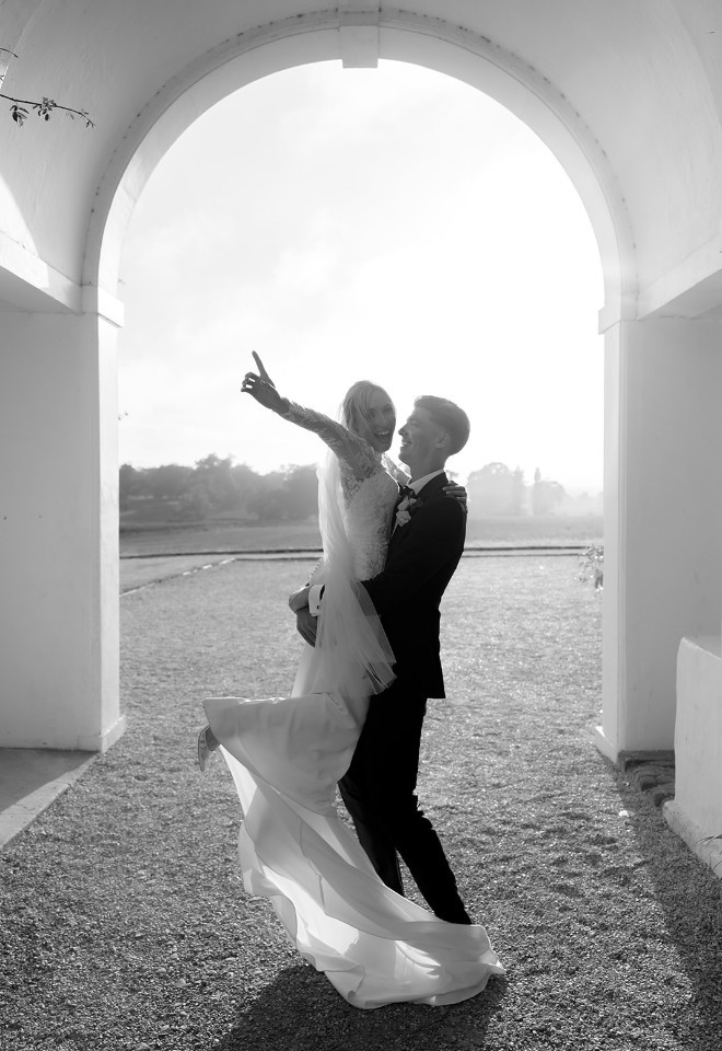 Happy Couple Celebrate Under Archway