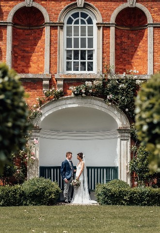 Bride and groom in the gardens at Chicheley Hall, Buckinghamshire