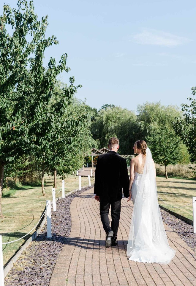 Bride & Groom walking along our pathway 