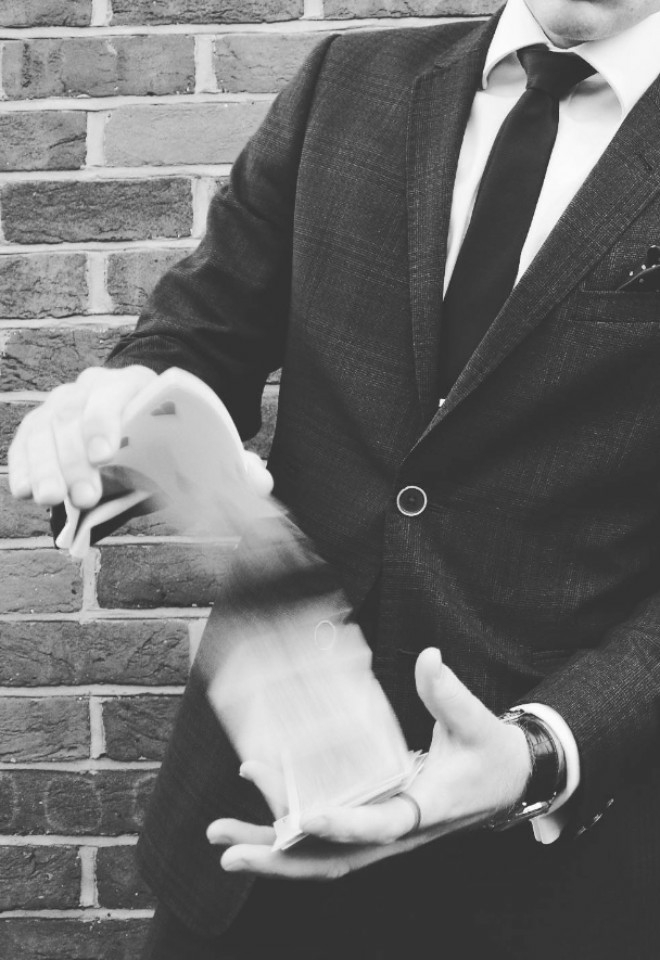 Nicky Georgr Magician performing card trick