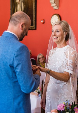 Bride and groom exchanging rings at Wokingham Town Hall, Berkshire