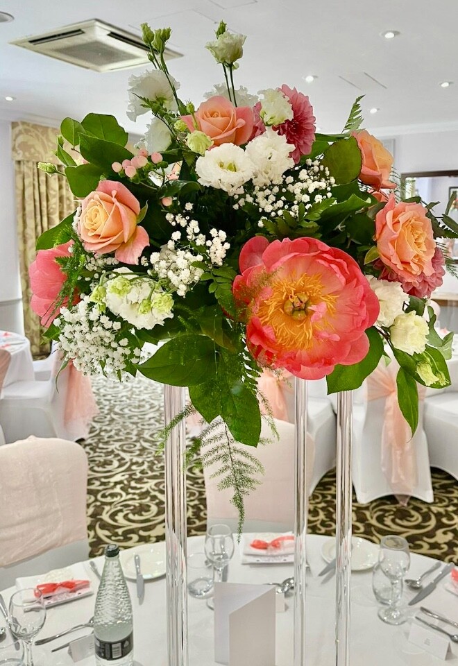 Gorgeous coral and white table centres