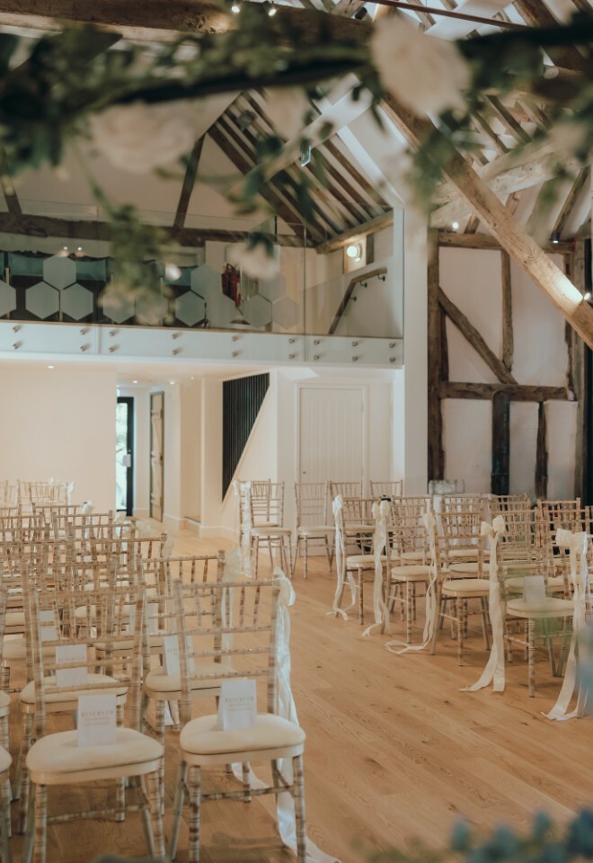 Wedding ceremony inside the barn at Alfriston Gardens near the South Downs National Park