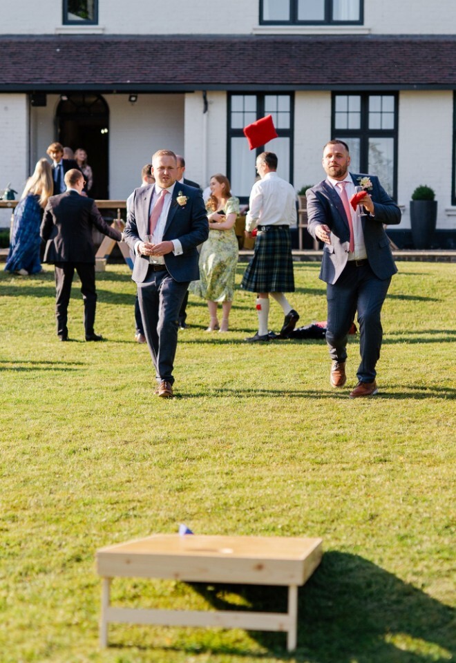Wedding guests enjoying their time in the garden playing games at a Warwickshire wedding venue