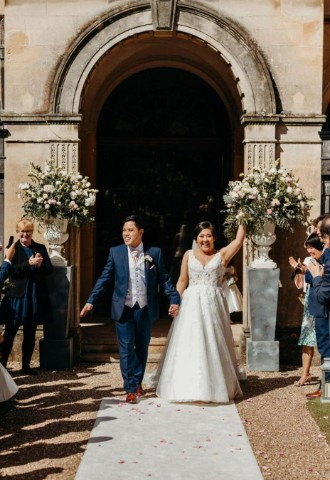 Bride and Groom walking out of Coombe Lodge
