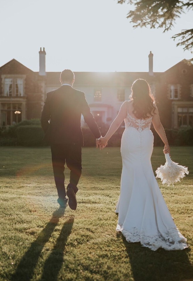 Bride and Groom standing outside on the grounds of Glewstone Court