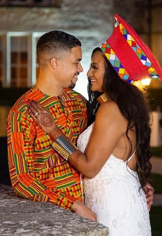 Couple embrace in traditional wedding dress