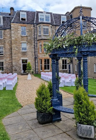 outdoor wedding ceremony with arch at The Fishers Hotel Wedding Venue