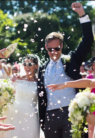 Wedding couple photo with confetti by Nigel Chapman