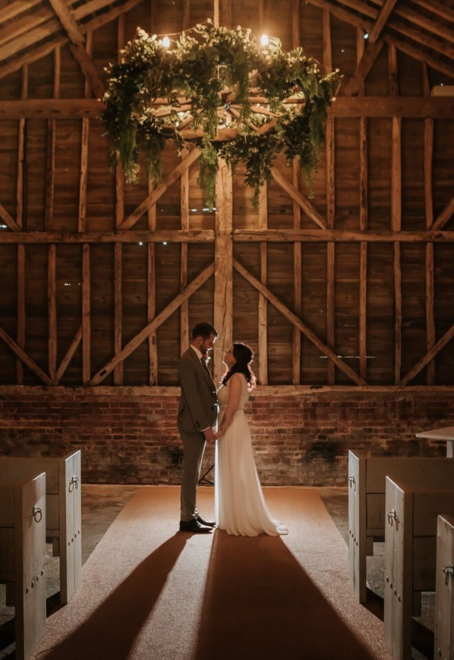A bride and groom standing the picturesque barn at a Hertfordshire wedding venue 