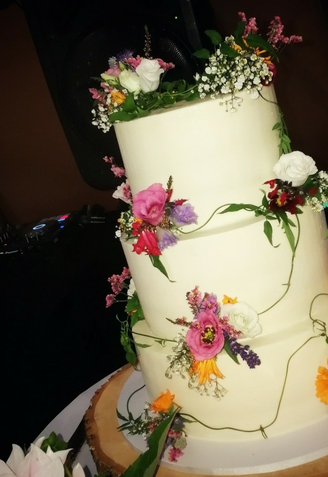 Wedding Cake with DJ setup in background at a Devon Wedding