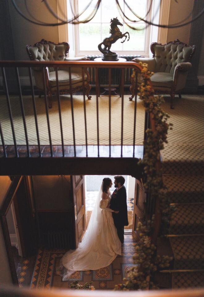 Bride and Groom stood in the Glewstone Court entrance hall 