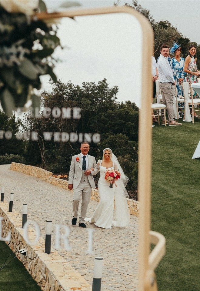 Mirror reflection of father and Daughter walking down the aisle at Casa Monte Cristo